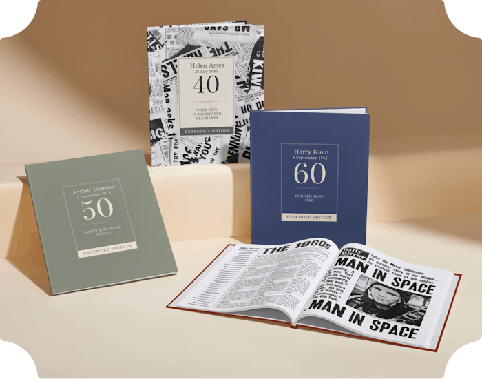three personalised covers and an open copy of the newspaper book