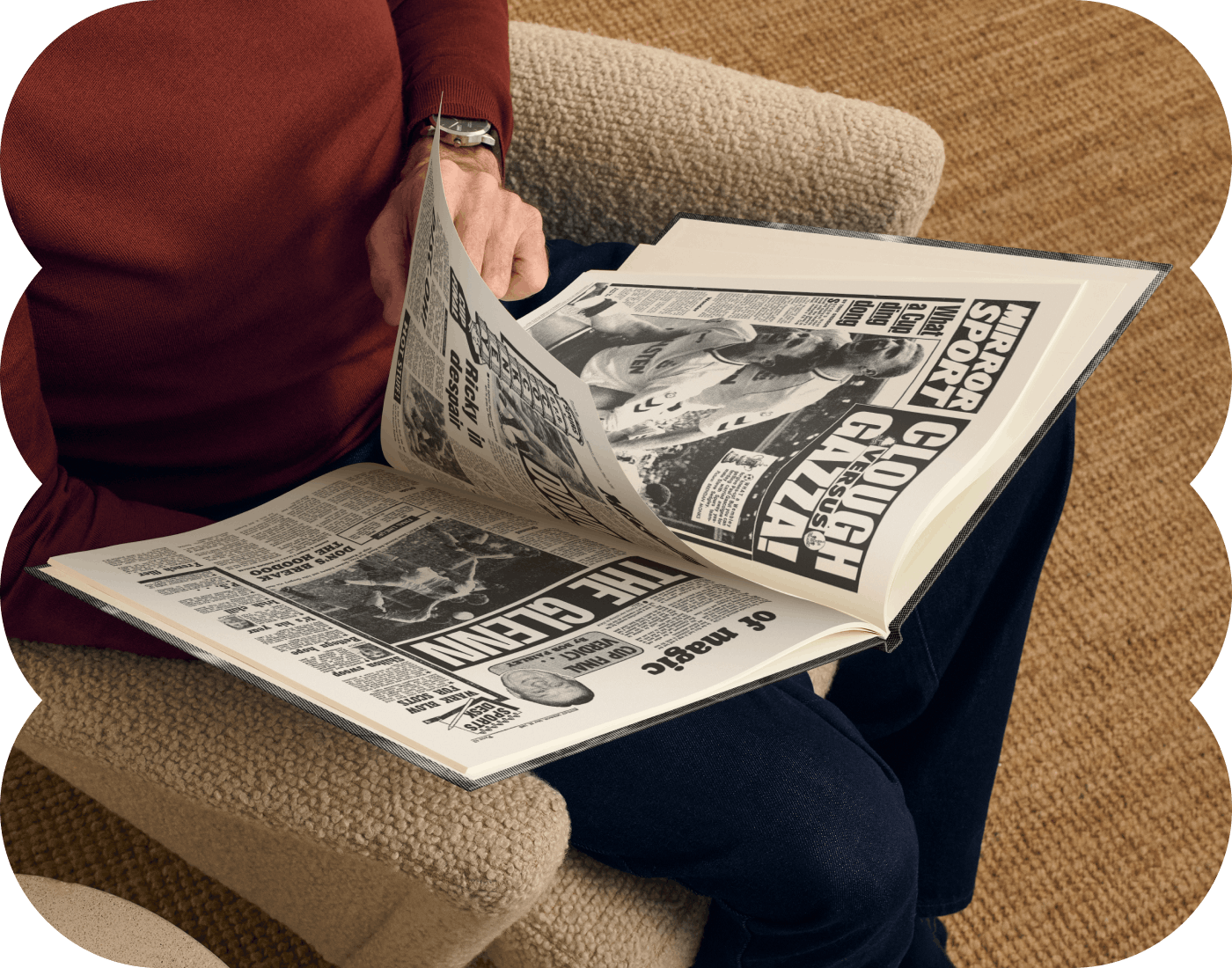An adult reading the football headlines in the book