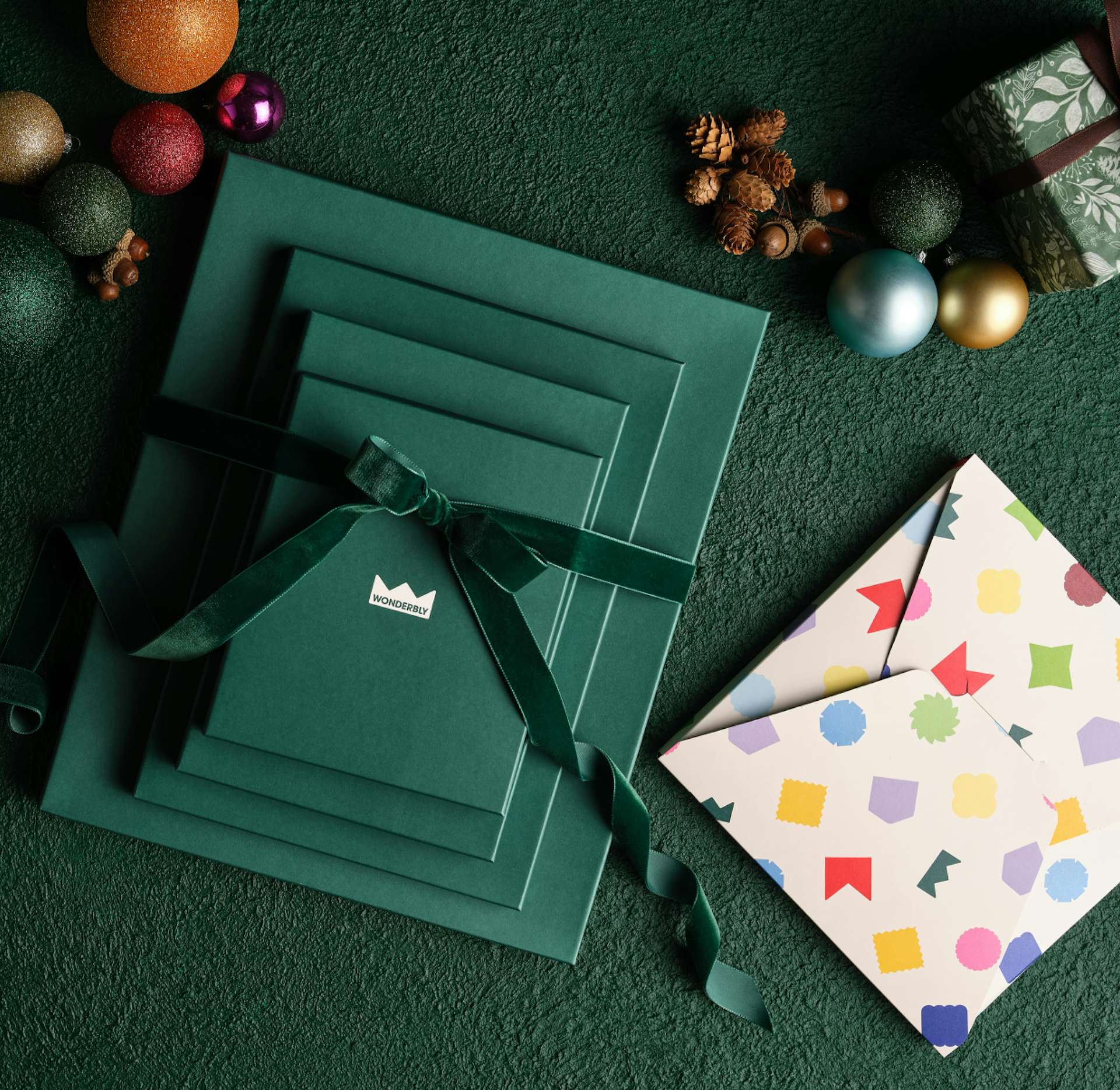 Green gift boxes with ribbon and multicolour gift wrap on festive background