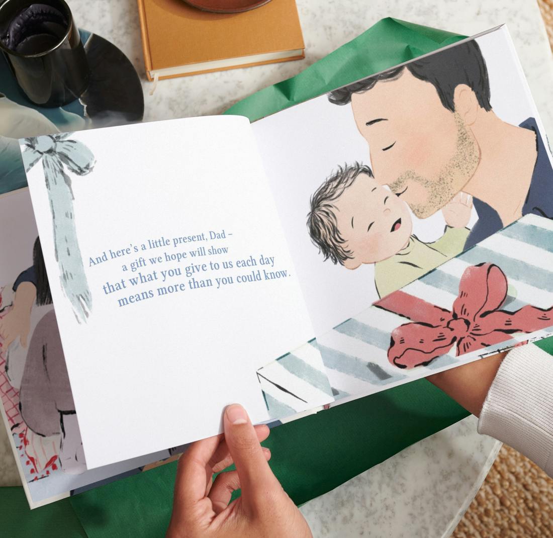 Two hands holding the open personalised book