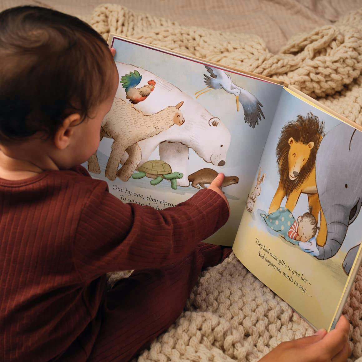 Child pointing to their personalised book