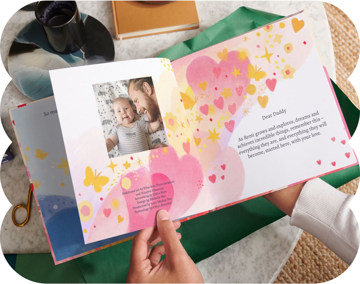 Two hands holding the open personalised book