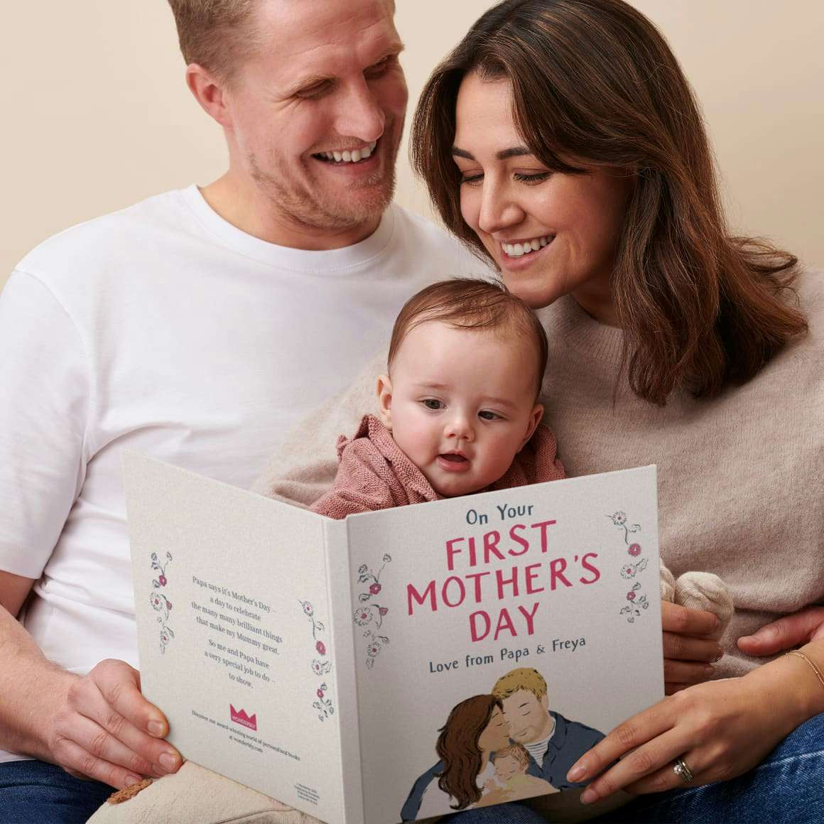 dad mum and baby reading book