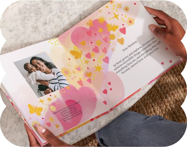 Two hands holding the open personalised book