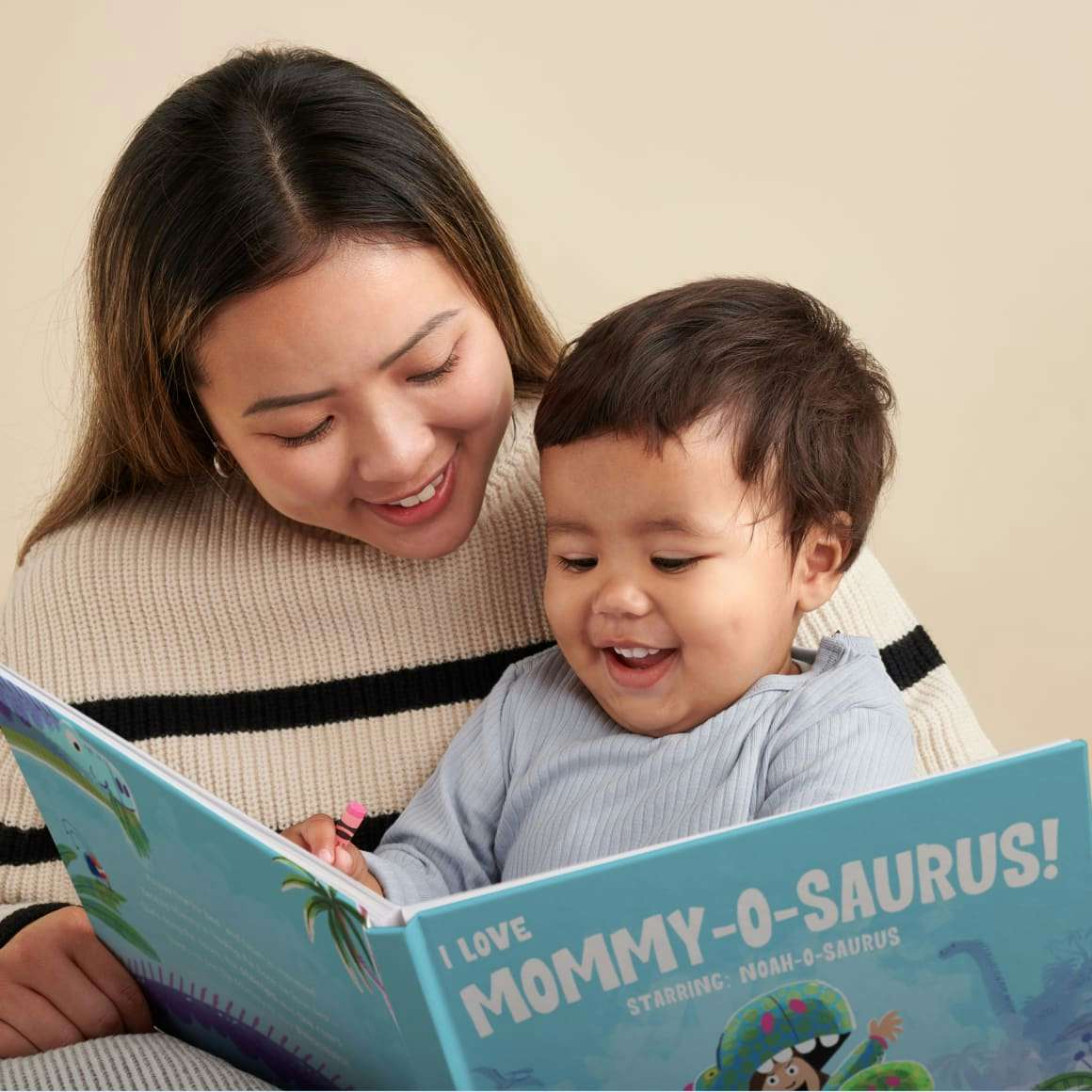 Mum and baby reading book together