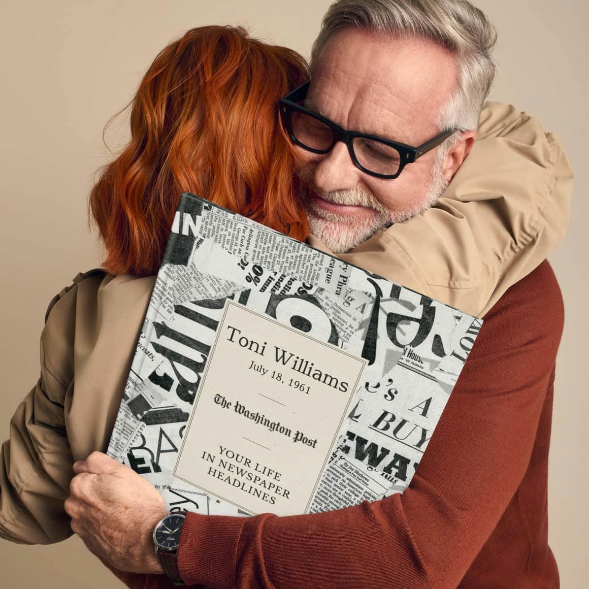 man and woman hugging gifting the book