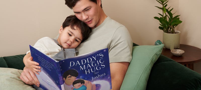 dad and kid hugging and reading