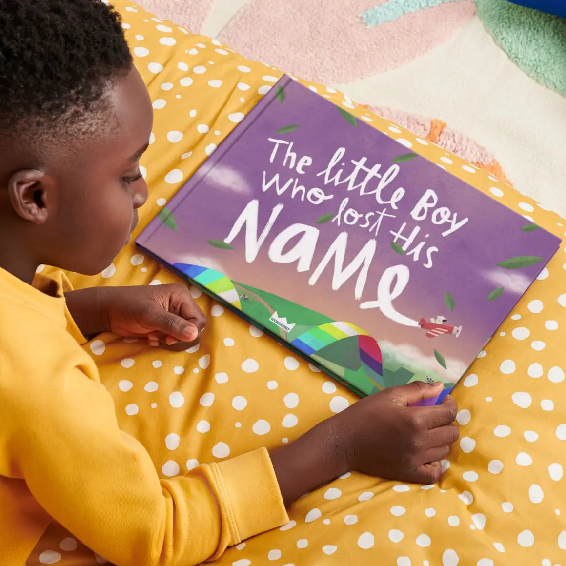 kid reading book on bed