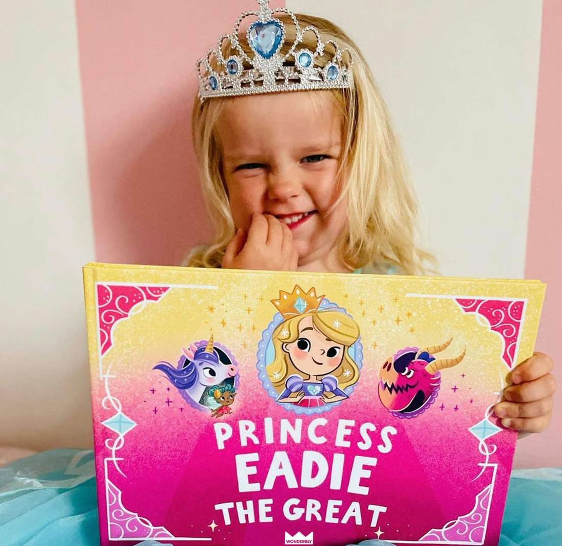 Girl holding personalized princess book