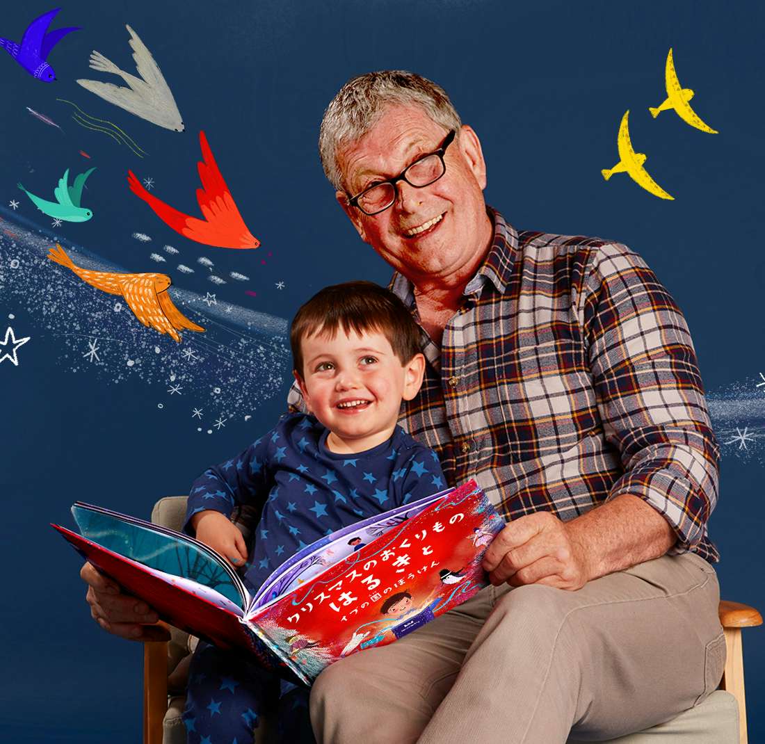 Grandad and grandson reading Christmas Wishes For You
