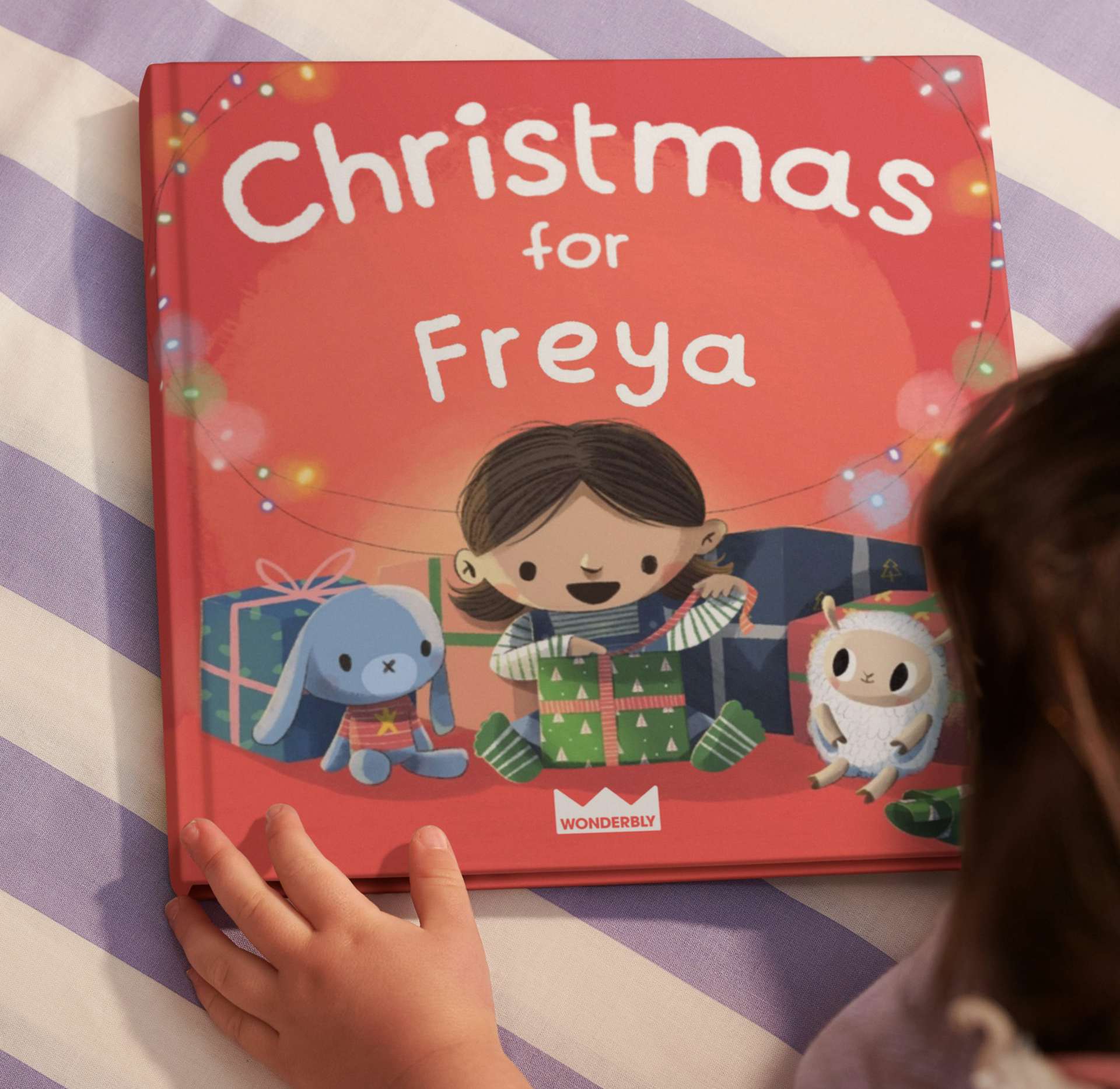 Child looking at personalised book cover
