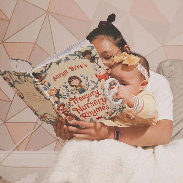Mother and baby reading personalized book