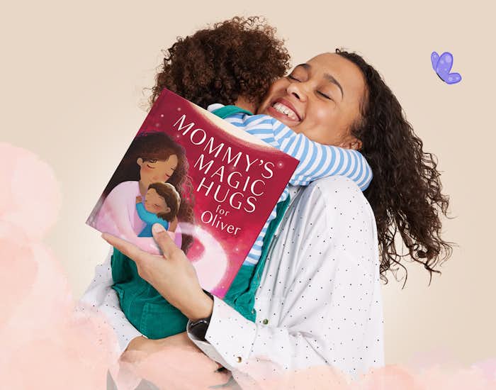 A mother hugging her child and holding the book