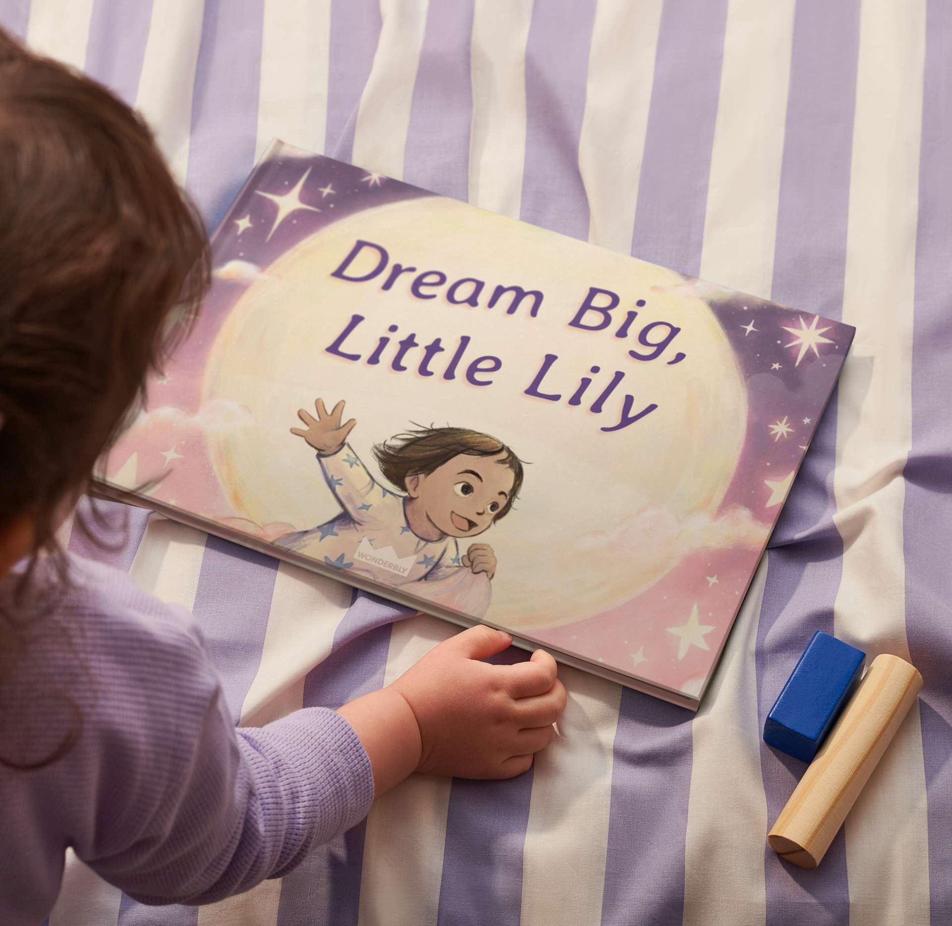 Child looking at book with their name