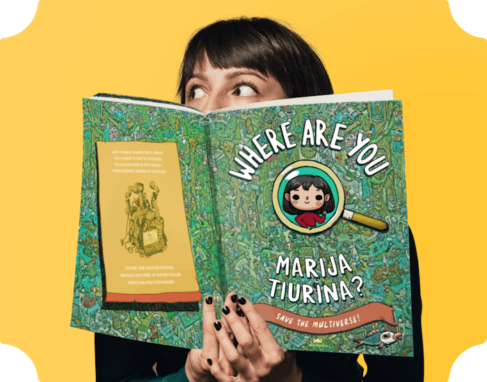 An image of our illustrator Marija Tiurina holding the book