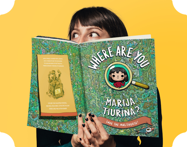 An image of our illustrator Marija Tiurina holding the book