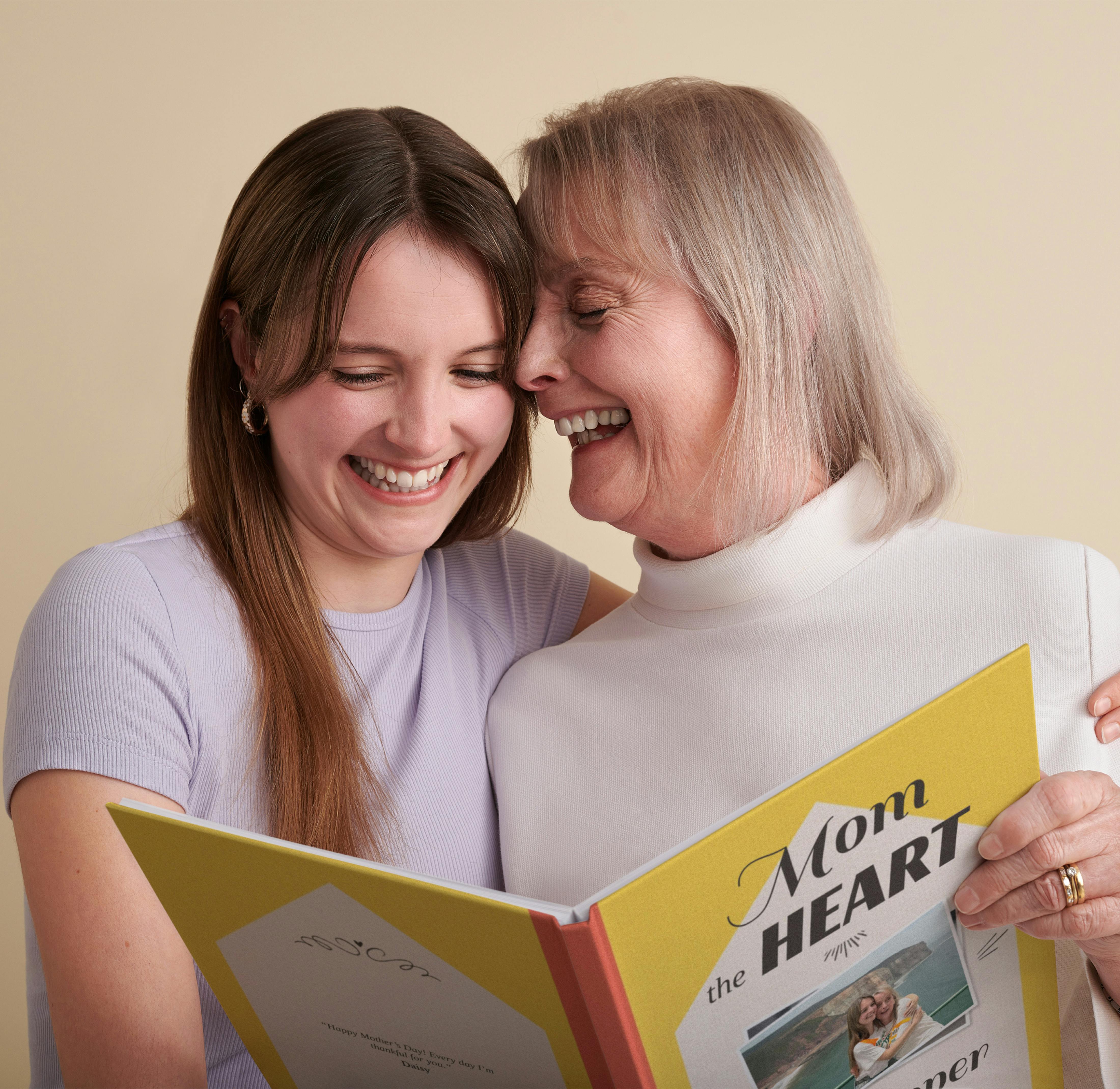 mother and daughter reading and smiling at personalised book