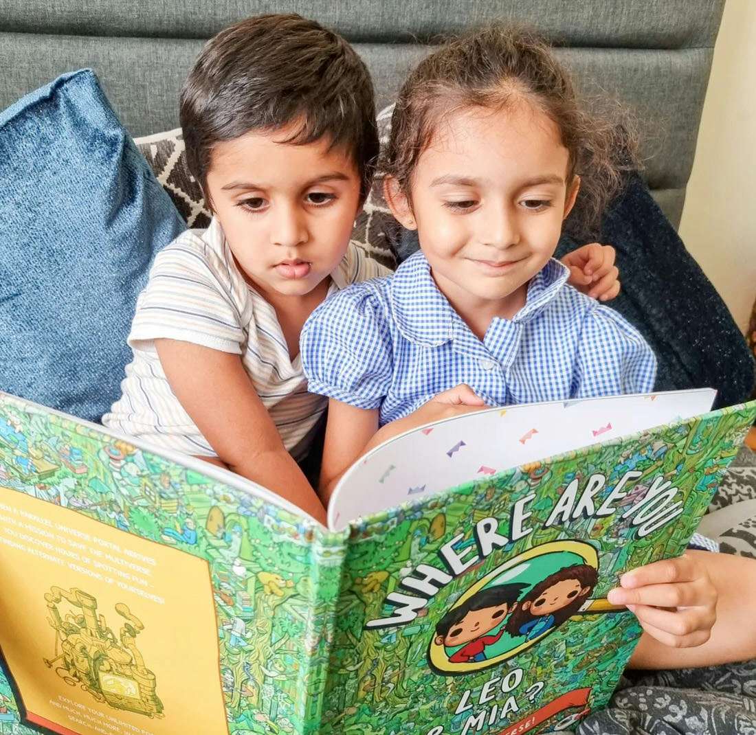 Siblings holding a personalised book