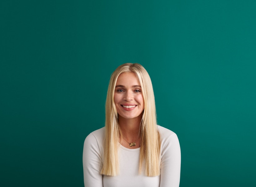 dark green background with woman smiling