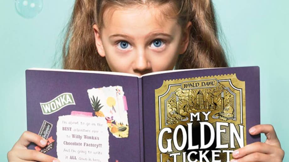 A little girl reading her personalised My Golden Ticket book