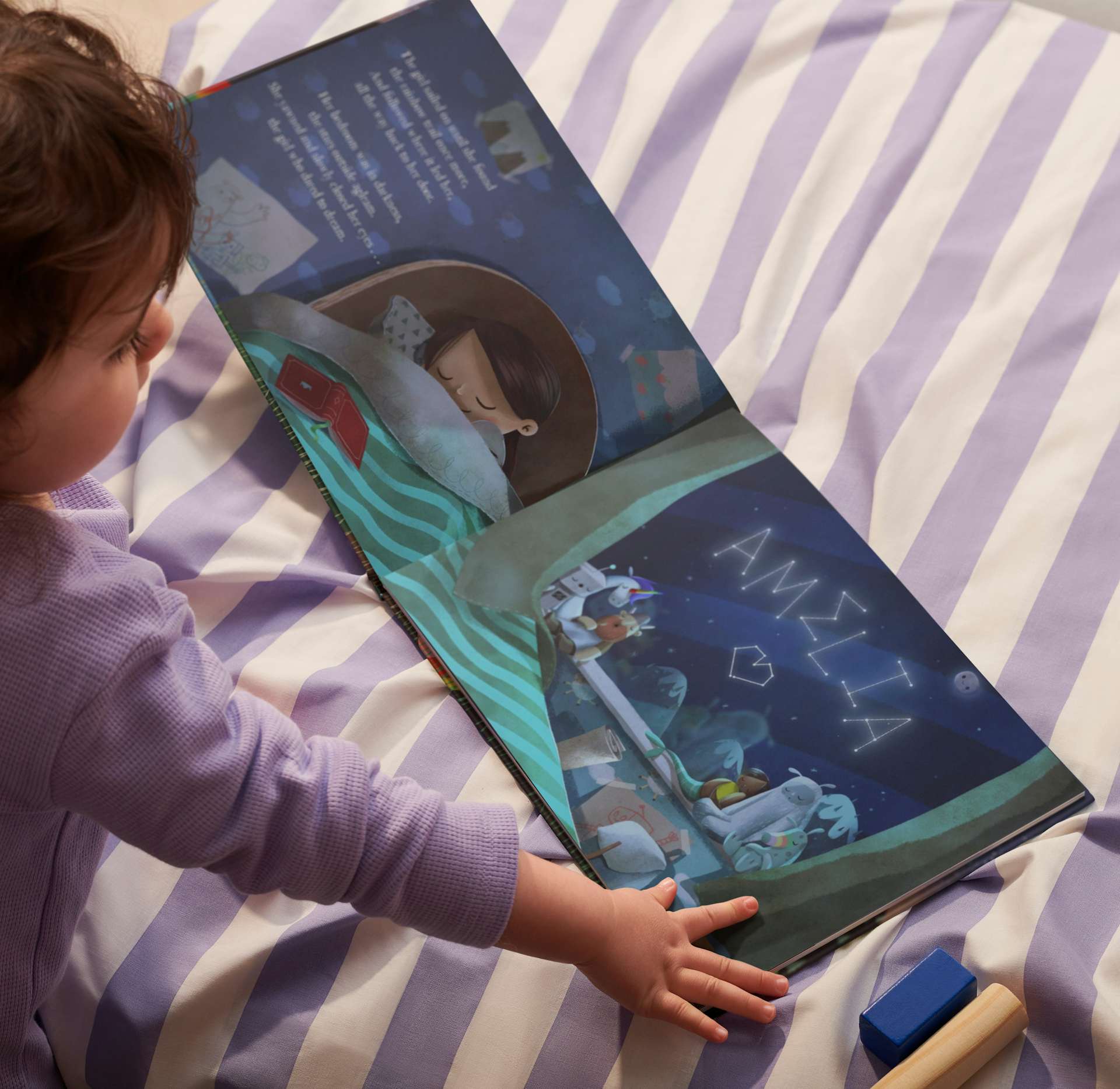 child reading the book with their name inside