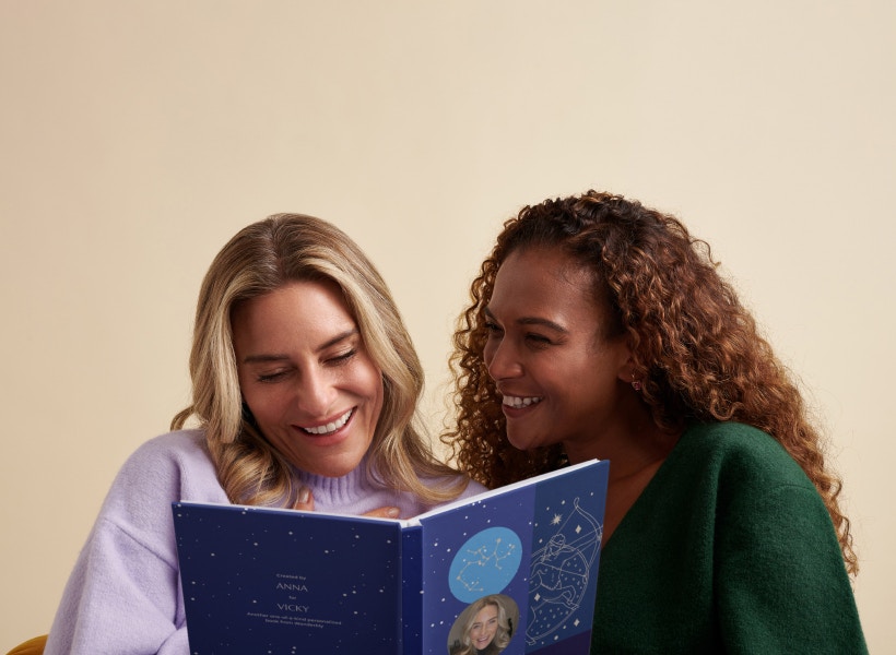 women reading astrology book