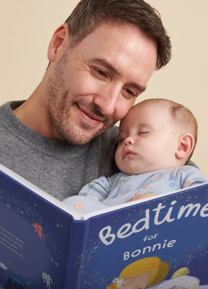 dad reading to sleepy baby