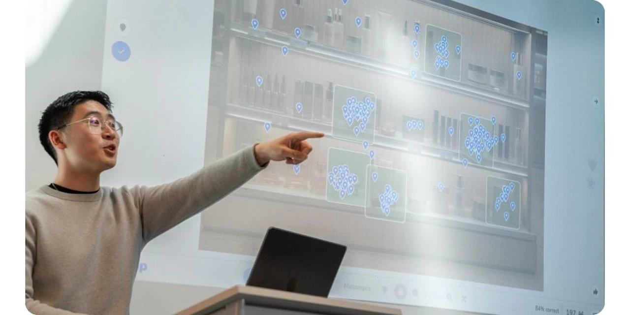 A trainer points at a screen displaying a Wooclap activity with location pins clustered over an image of a retail shelf, engaging the audience in real time.