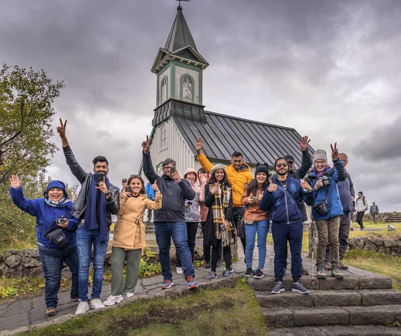 Happy people in front of an Icelandic church