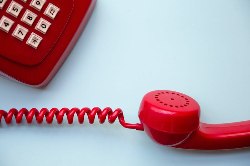 A red telephone with a cord