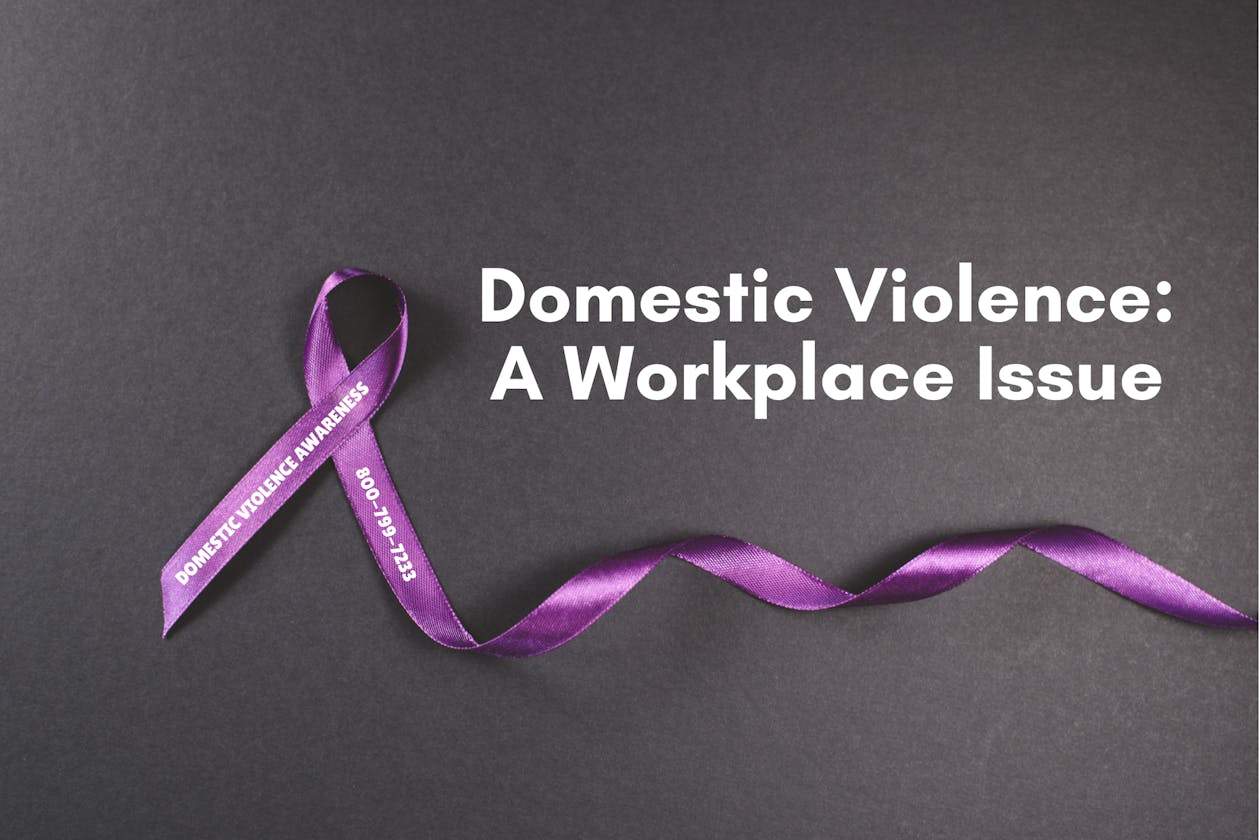 A purple ribbon with the words "Domestic Violence Awareness" and "800-799-7233"