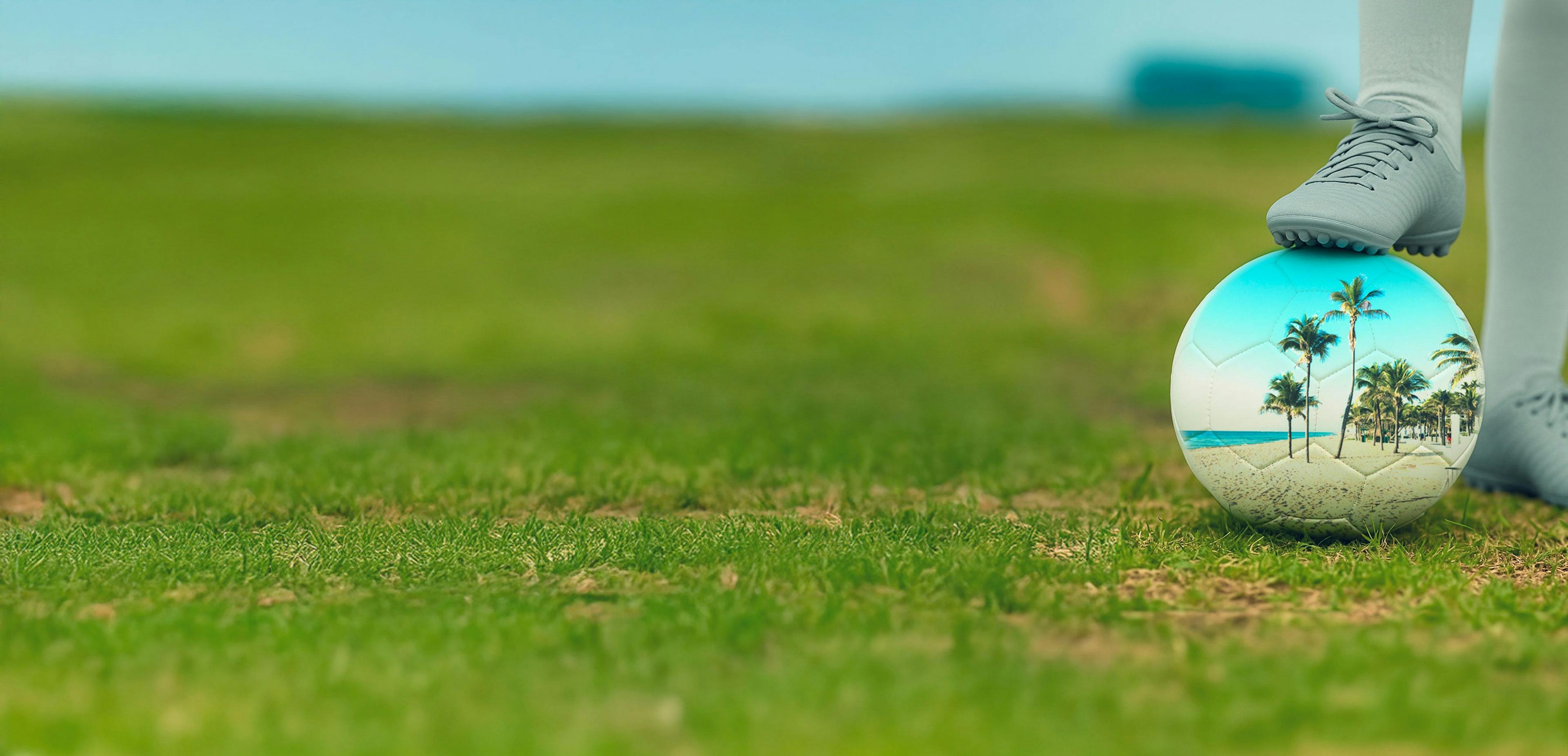 Womens Soccer Player places cleat on top of soccer ball with a palm tree design in Fort Lauderdale Florida