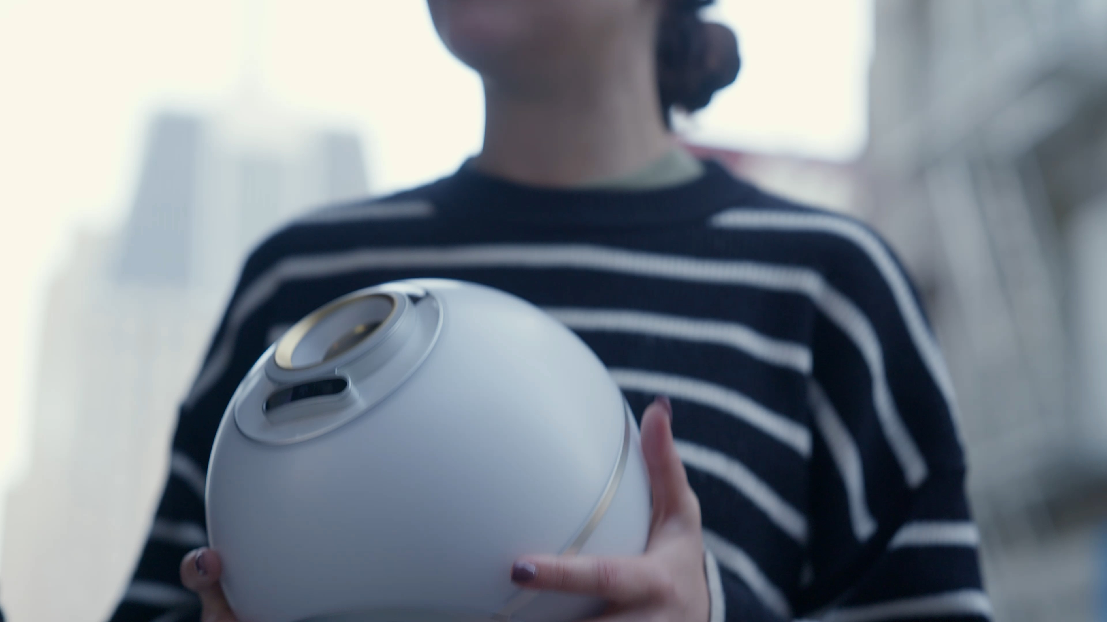 A person holding an Orb, showcasing community engagement and technology.