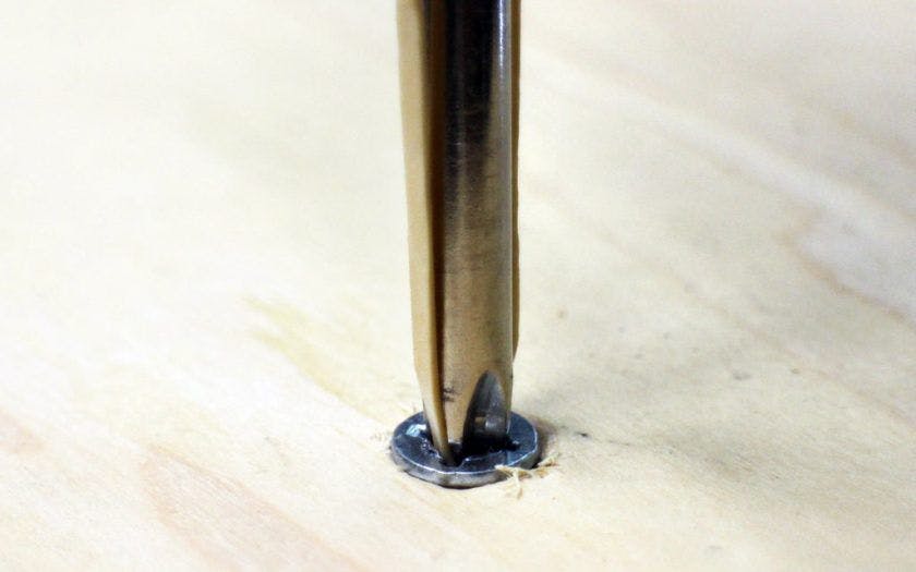 Screwdriver on screw in wood
