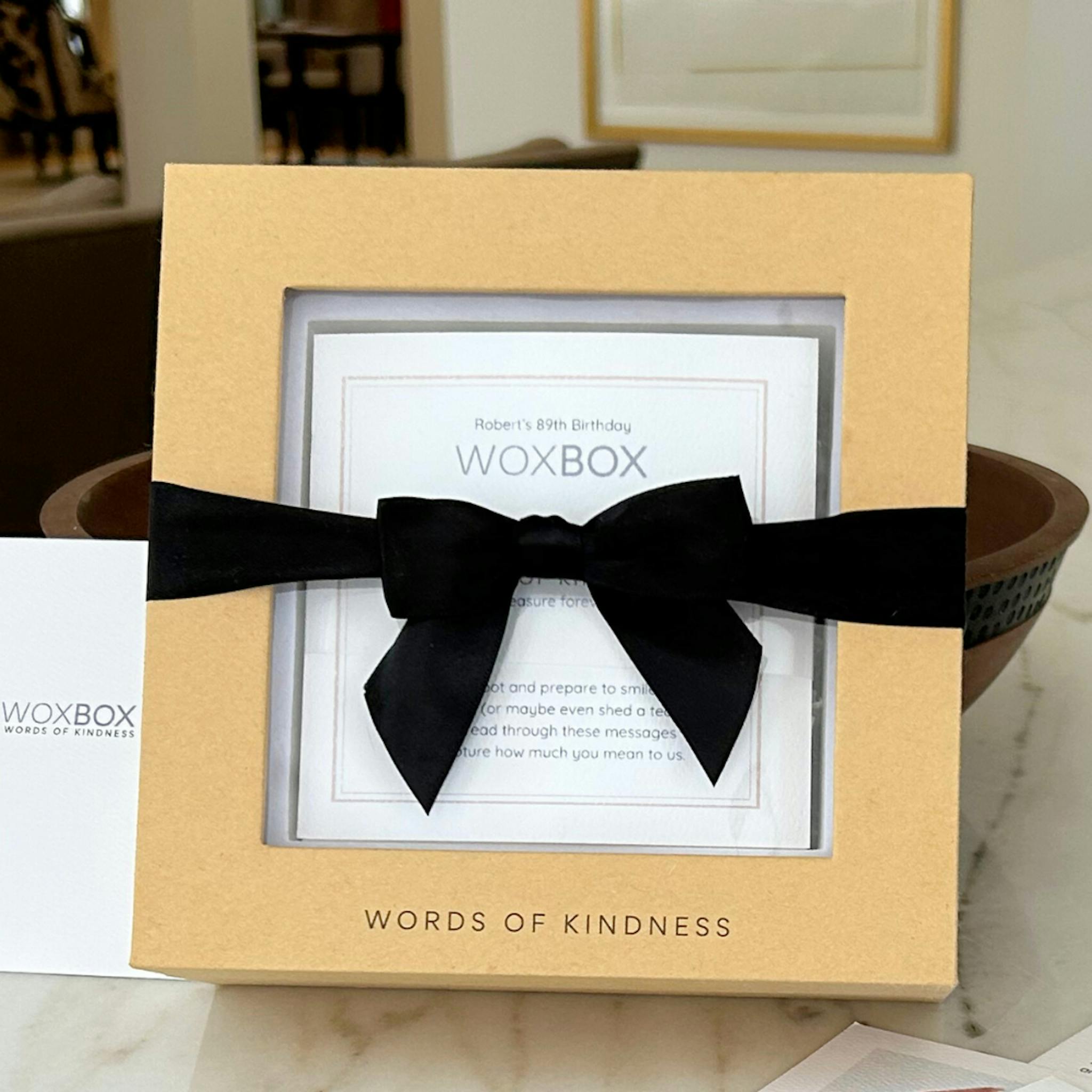 The ultimate feel-good gift with black satin ribbon, by Woxbox