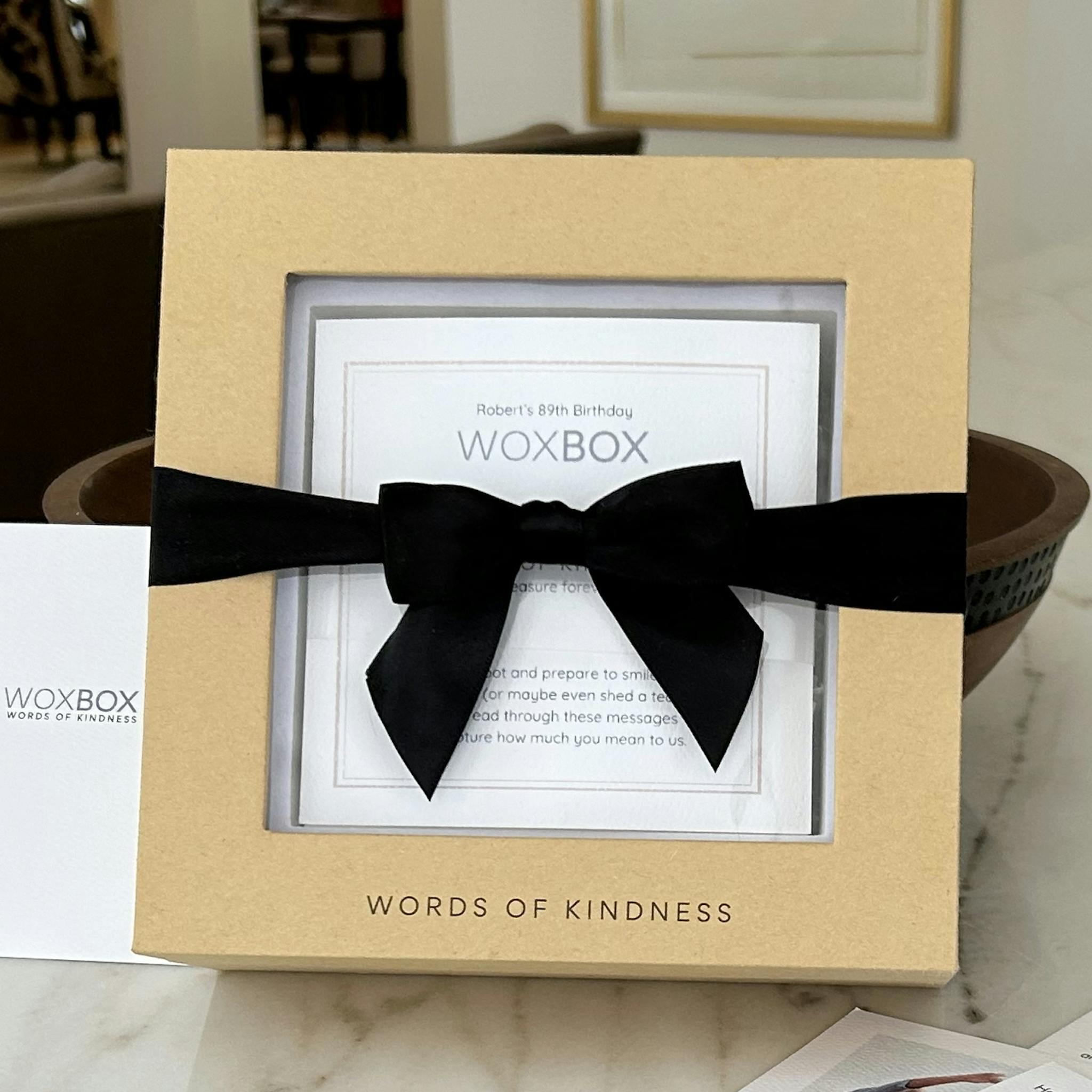 The ultimate feel-good gift with black ribbon, by Woxbox