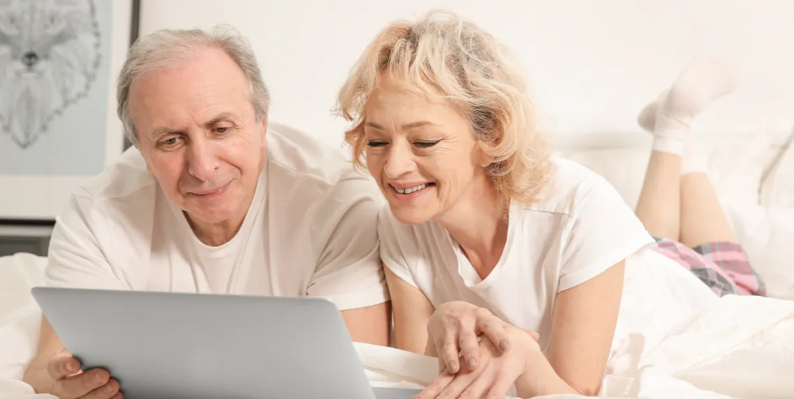 Grandparents smiling while on a video call with family