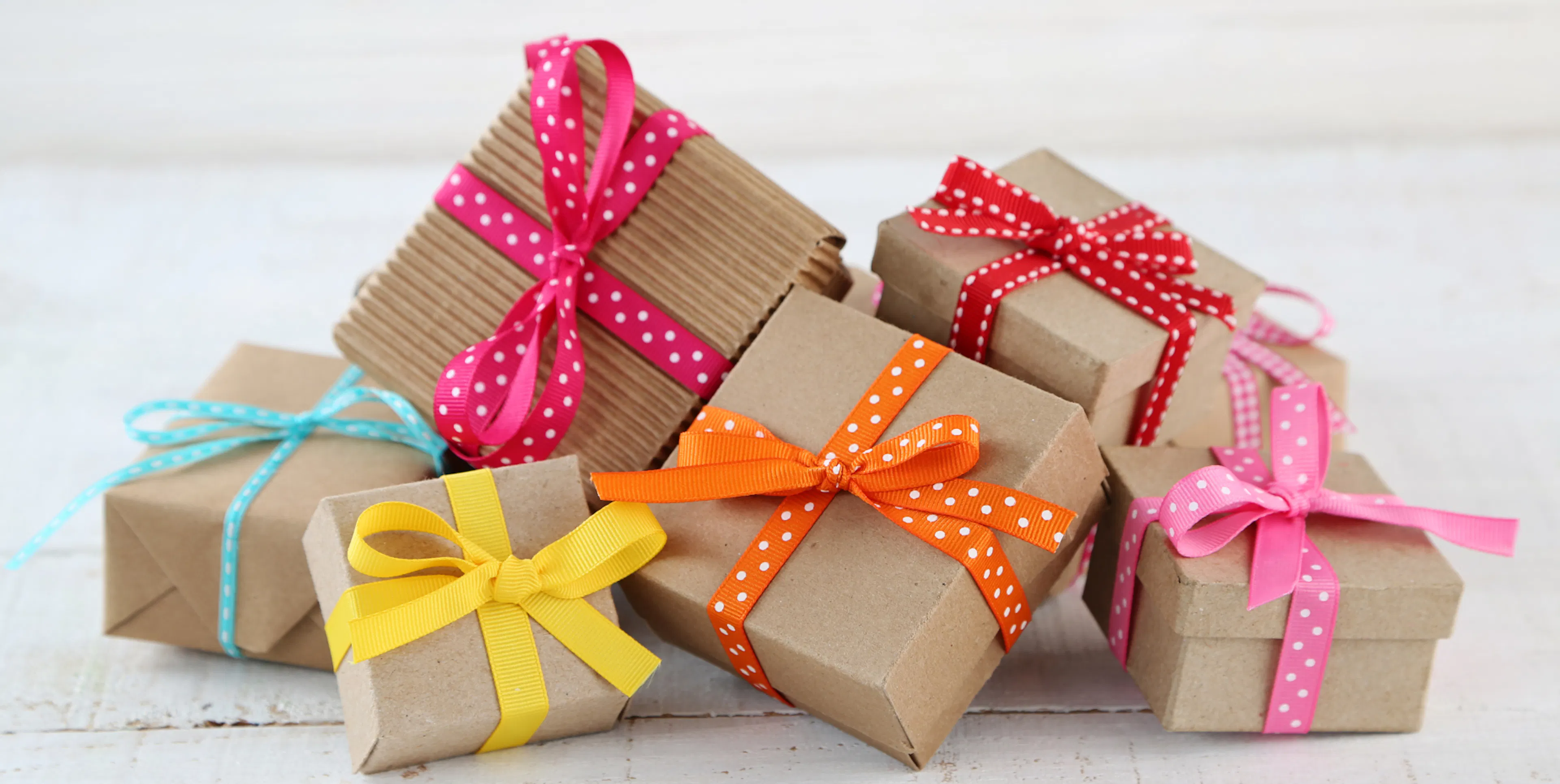Pile of wrapped birthday gifts on a table