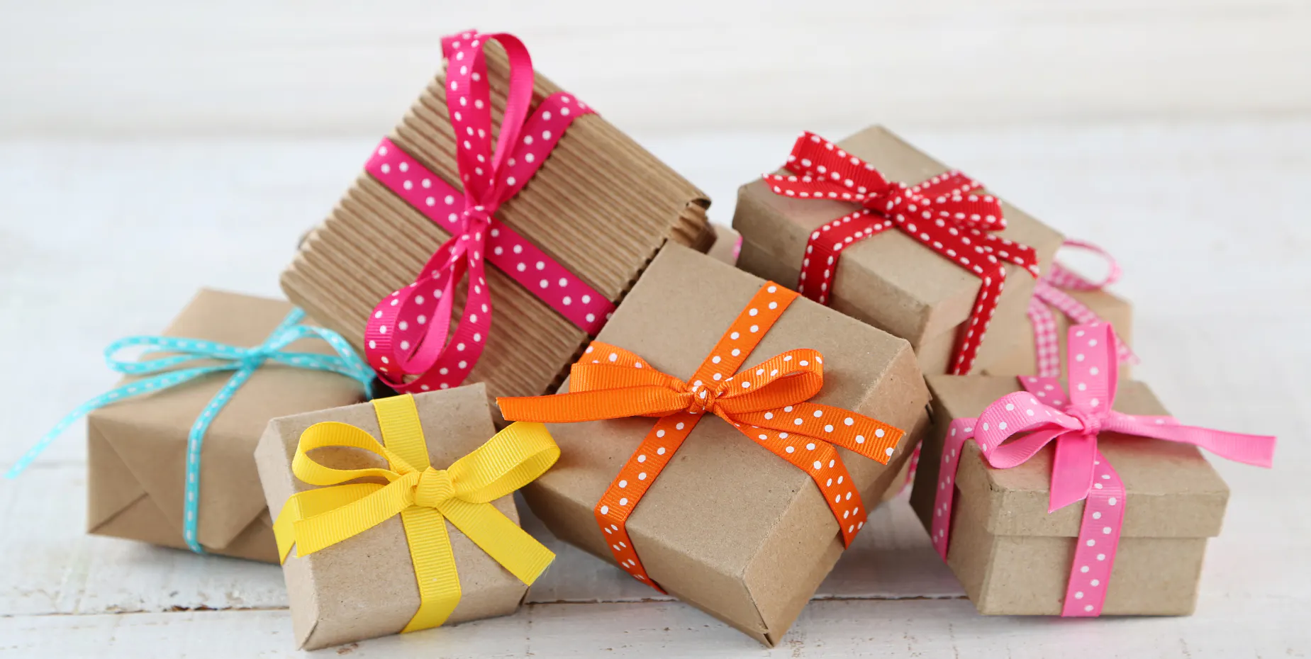 Pile of wrapped birthday gifts on a table