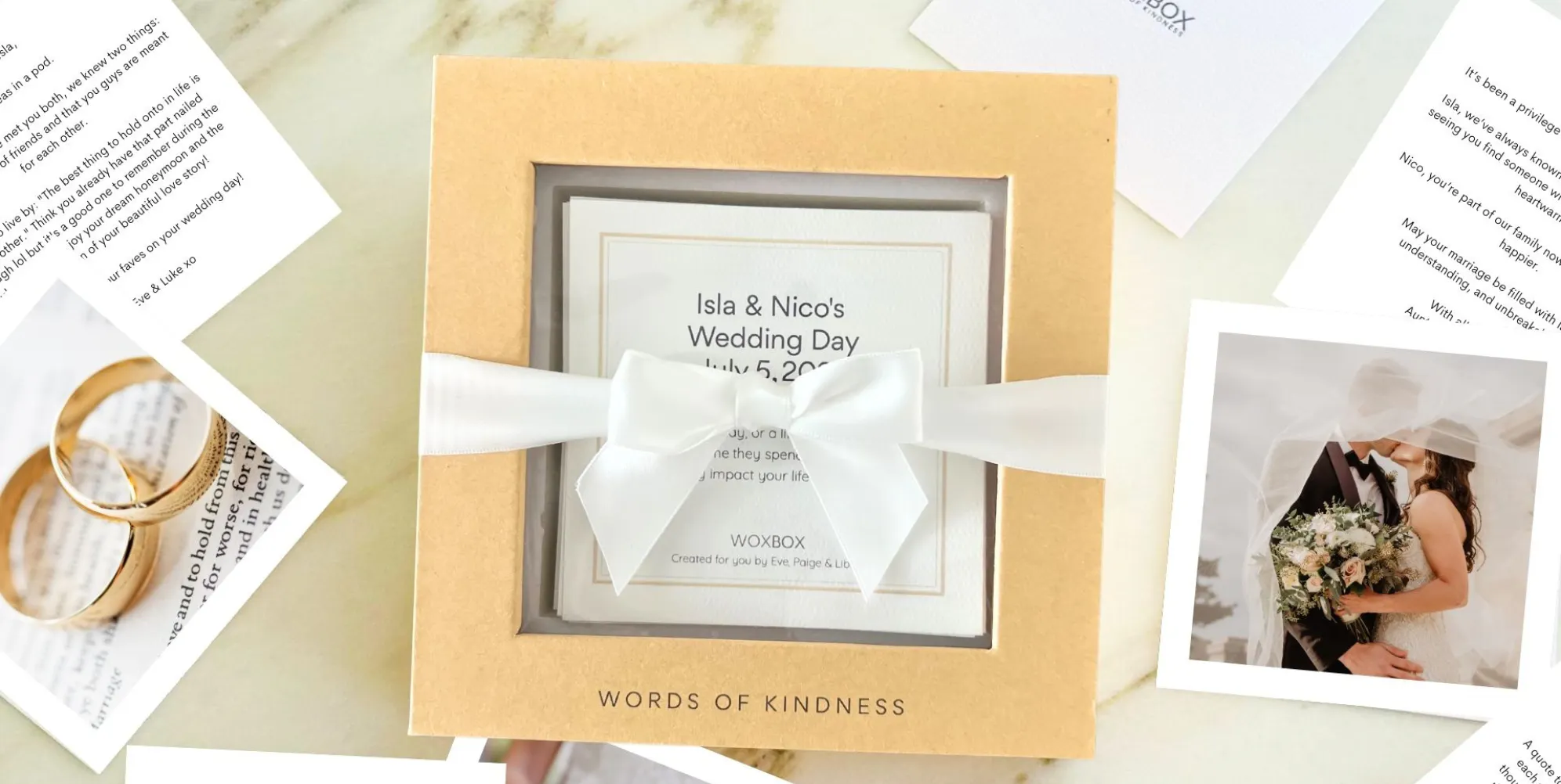 Woxbox wedding keepsake gift from a group on a table with personal messages and photos printed on card stock scattered around it