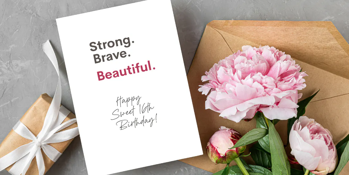 Sweet 16 birthday gift with flowers and a card that reads "Strong. Brave. Beautiful. Happy Sweet 16th Birthday!"