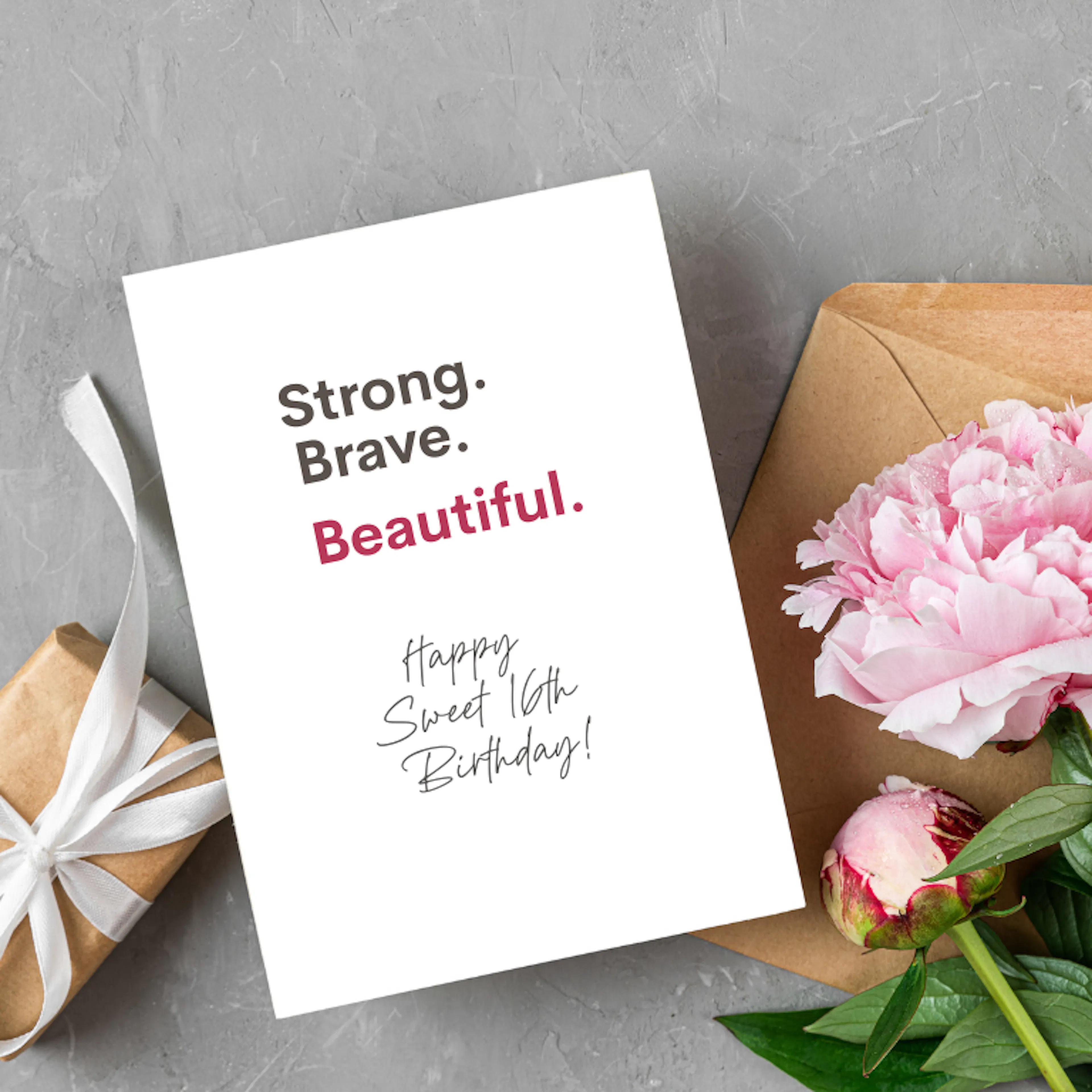 Sweet 16 birthday gift with flowers and a card that reads "Strong. Brave. Beautiful. Happy Sweet 16th Birthday!"
