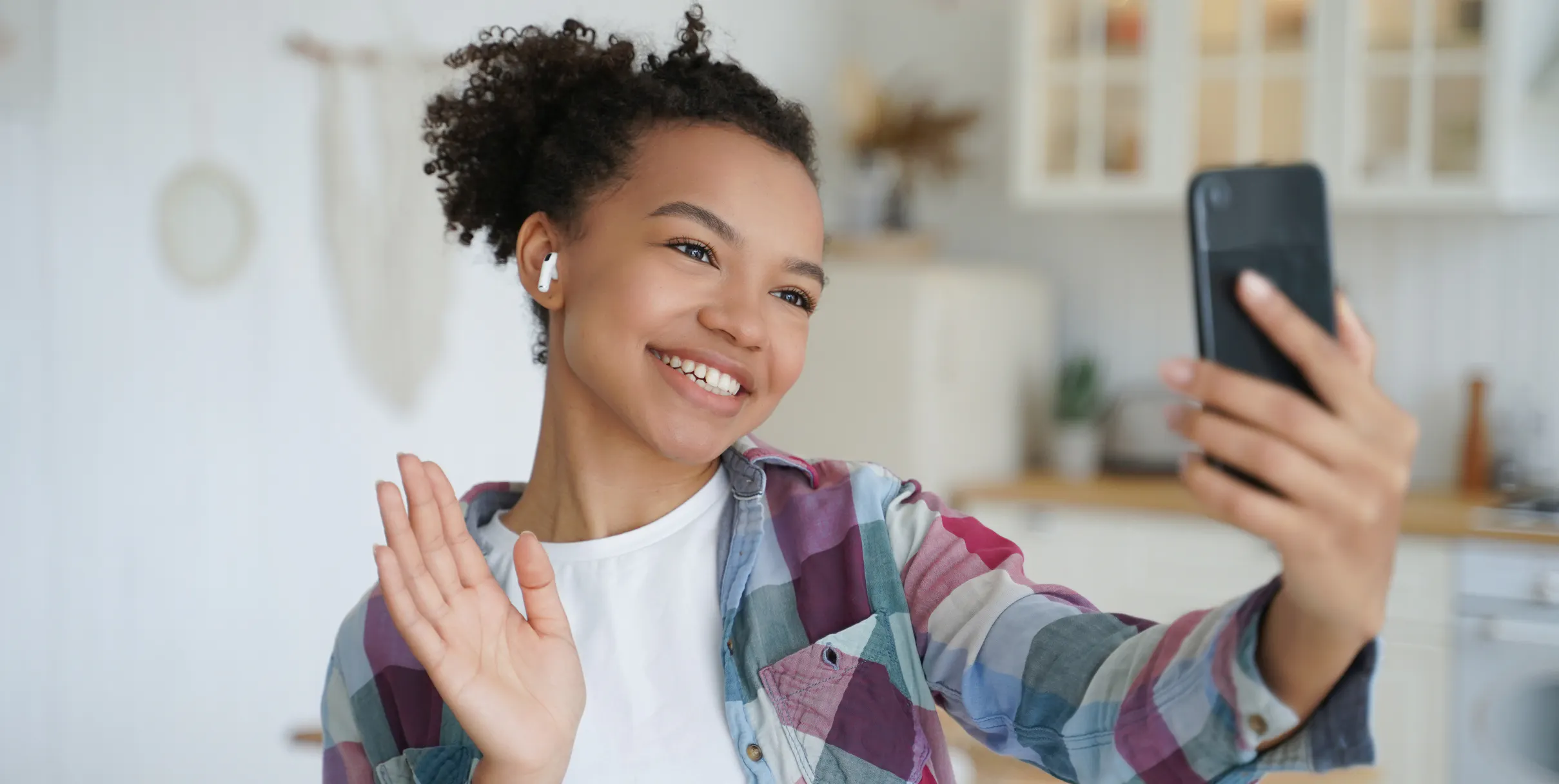 Woman smiling while she's on a video call with her brother to say hello