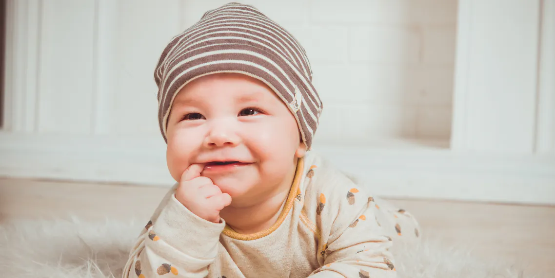Smiling baby representing the moments and photos to preserve in a baby's first year Woxbox