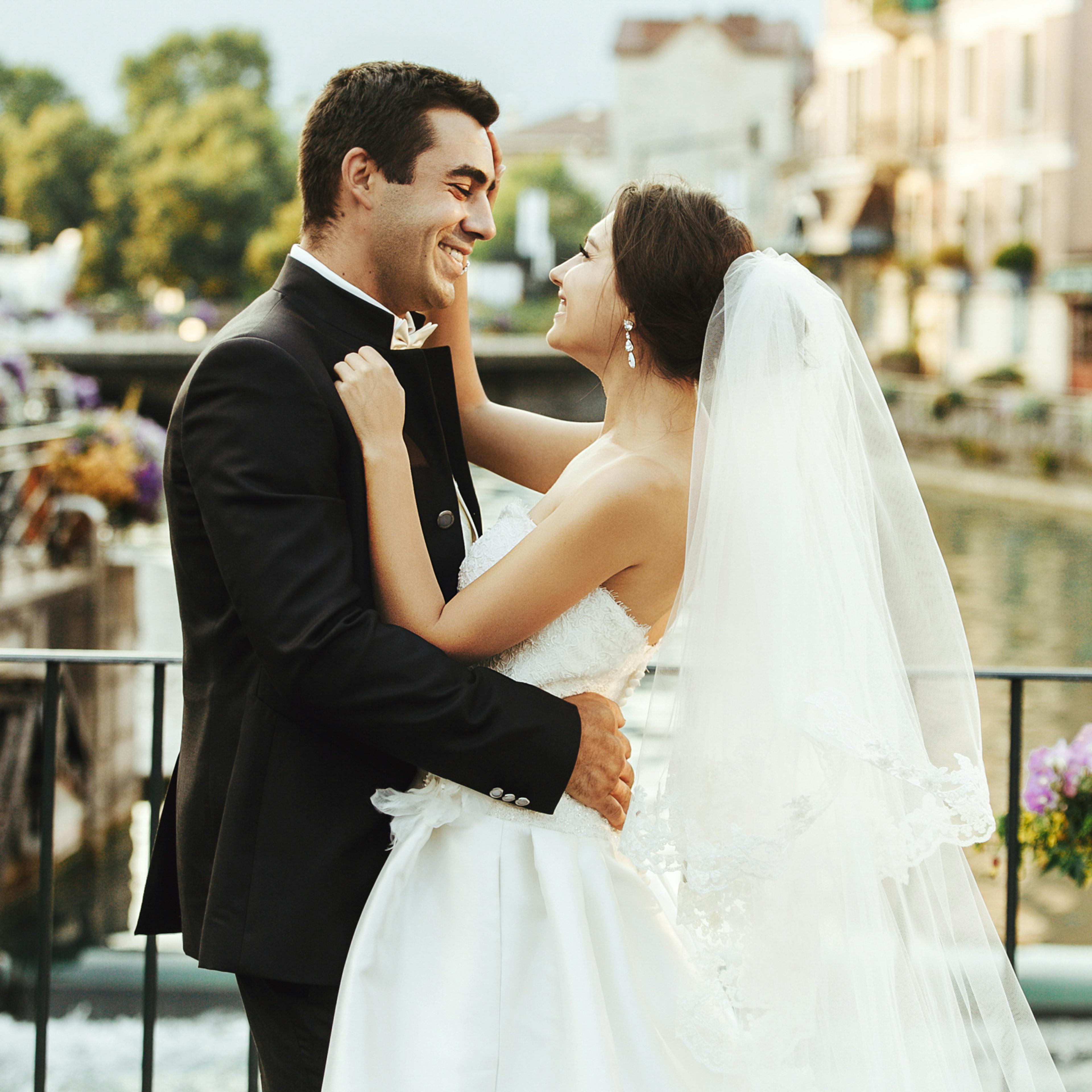 Bride and groom embracing and looking into each other's eyes, by Woxbox Gift