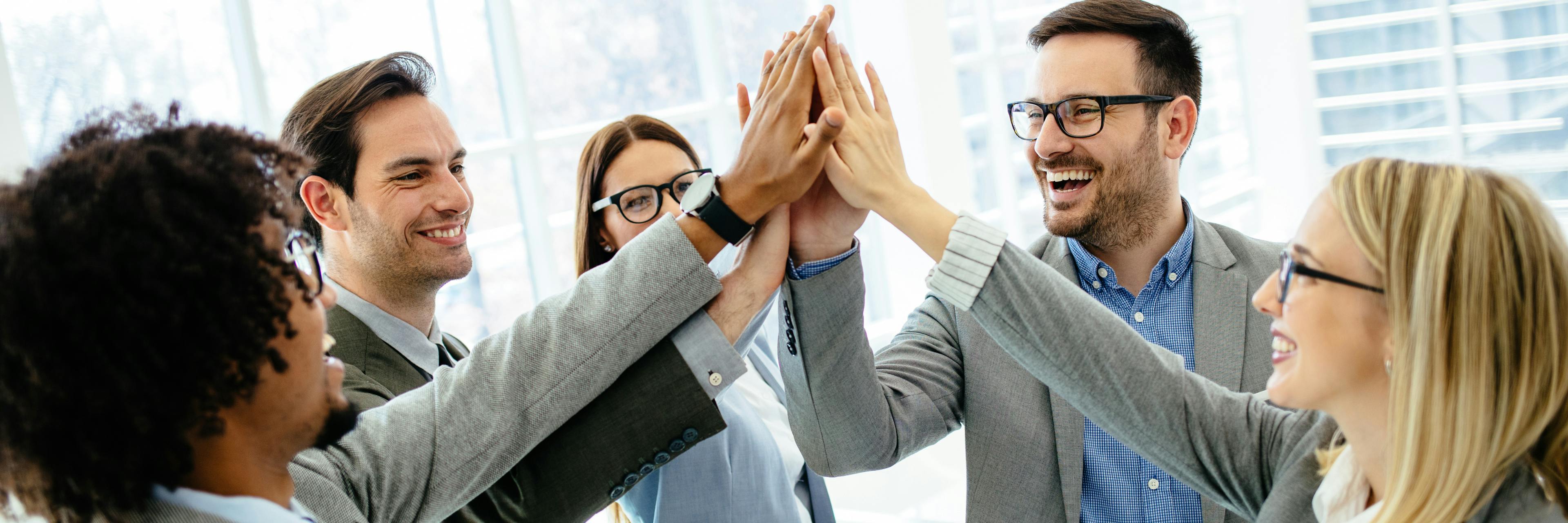 Corporate team giving each other a high-five, by Woxbox Gift