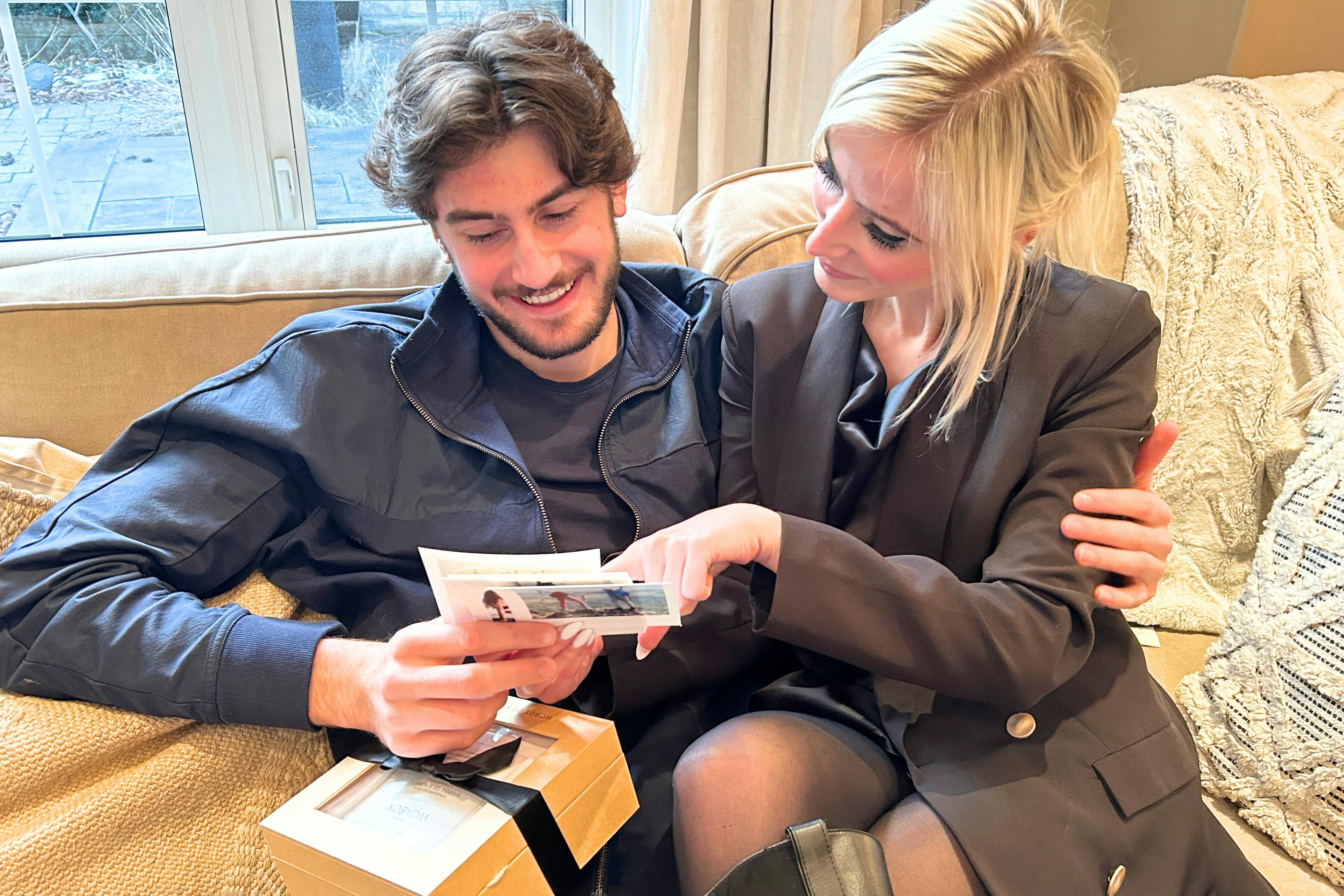 Young couple reading thoughtful messages in their 21st birthday gift, by Woxbox