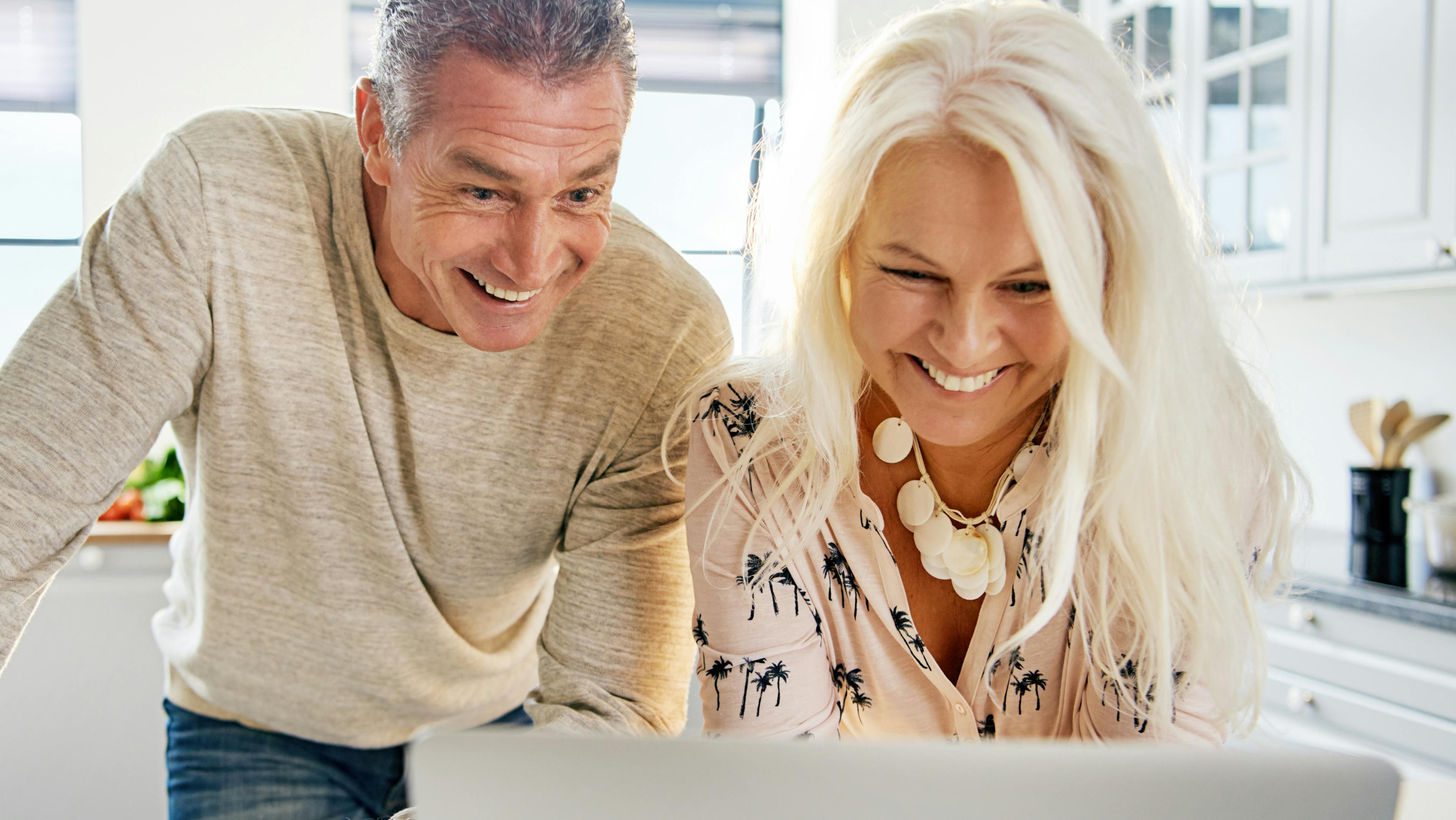 Retired couple reading their digital Woxbox thoughtful retirement gift