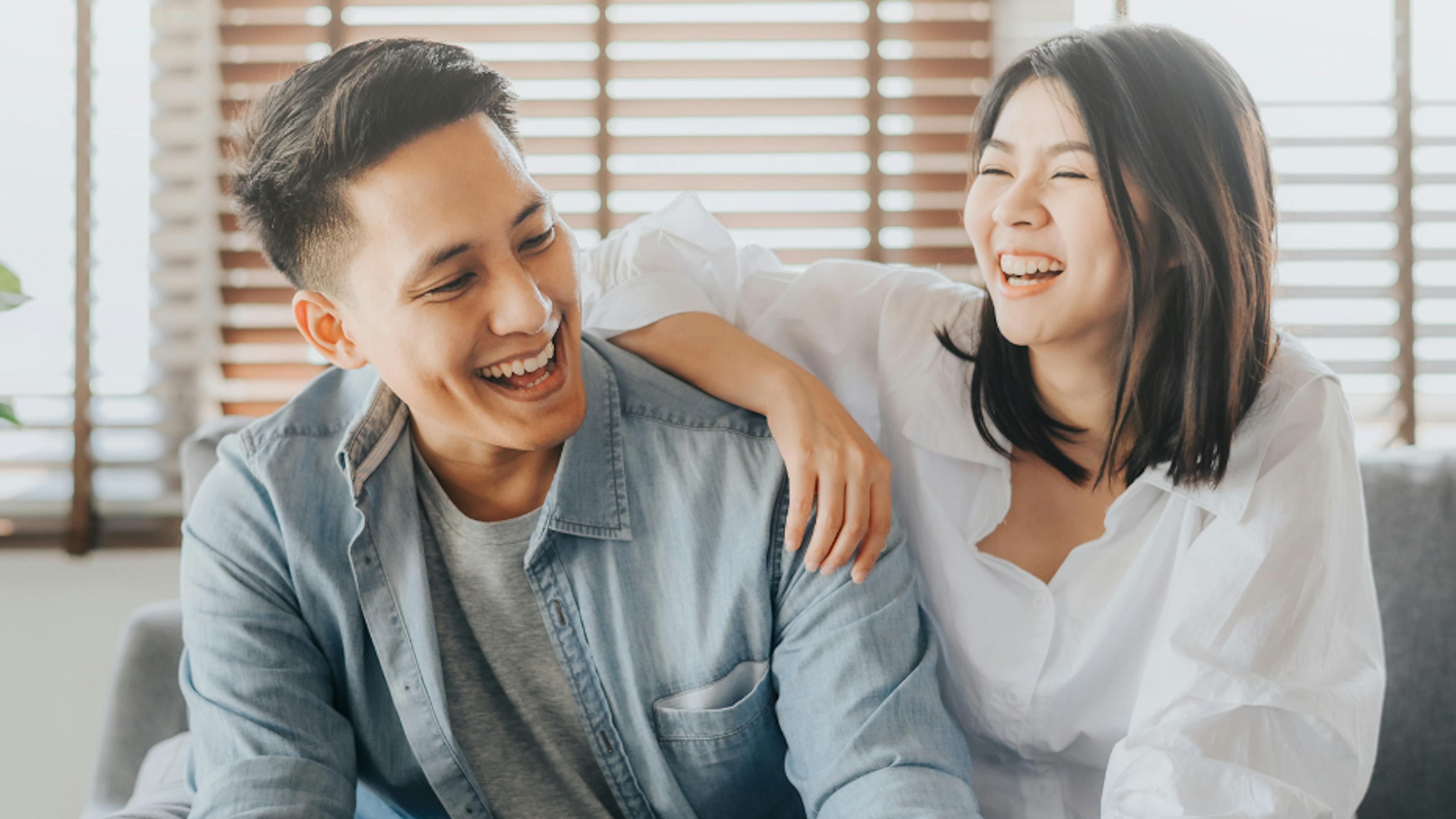 Young asian couple laughing on their anniversary