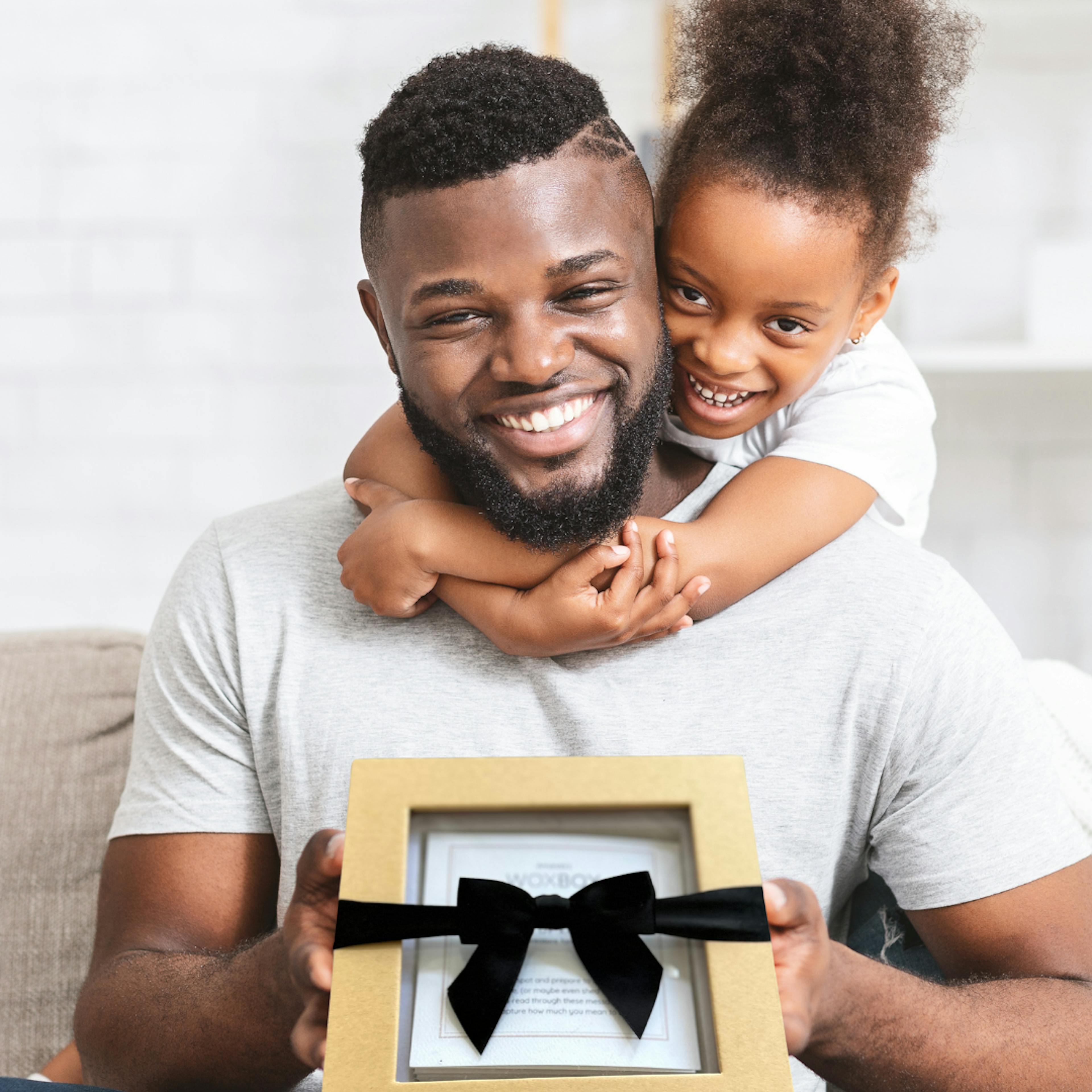 Child giving her dad a Woxbox for father's day